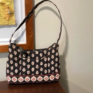 Small Vera Bradley purse. Black background with white, red, tan, gray accents.